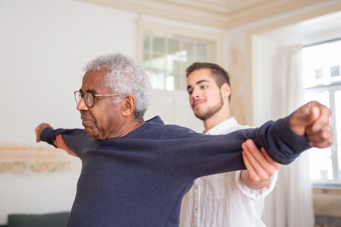 A therapist guiding a resident through gentle strengthening exercises